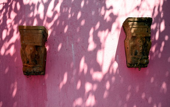antefix on a pink wall