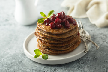 Homemade chocolate pancakes with cherry sauce