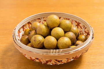 Fresh longan in Bamboo bowl isolated