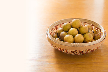 Fresh longan in Bamboo bowl isolated