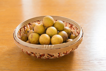 Fresh longan in Bamboo bowl isolated