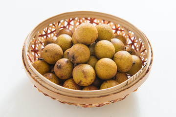 Fresh longan in Bamboo bowl isolated