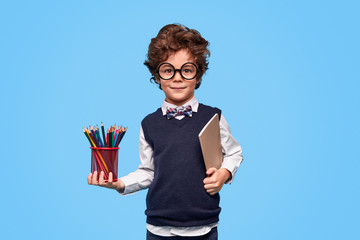 Clever schoolboy with stationery