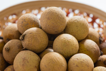 Fresh longan in Bamboo bowl isolated