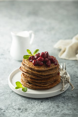 Homemade chocolate pancakes with cherry sauce