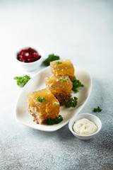 Festive meat jelly with sauces on white plate