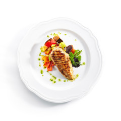 Top View of Grilled Chicken Fillet with Side Dish of Baked Vegetables