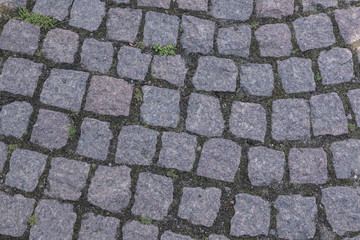 A fragment of a stone road made of chipped stone. Close-up.