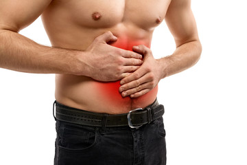 Naklejka premium Shirtless man having stomach ache