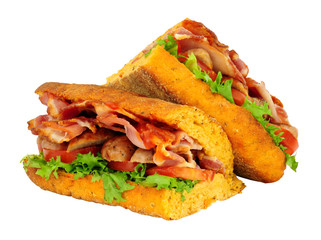 Sausage and bacon filled ciabatta bread sandwiches with lettuce and tomato isolated on a white background