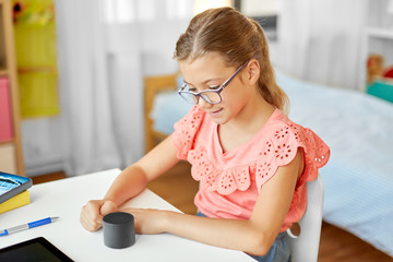 children, education and technology concept - student girl using smart speaker at home