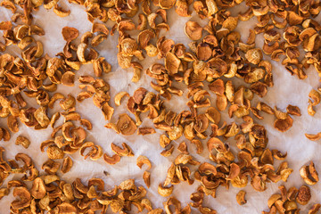 Dried fruits apples and pears scattered on the canvas as a background
