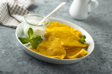 Homemade turmeric pancakes with cream