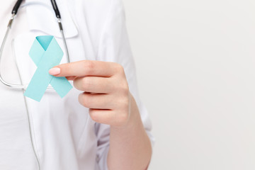 Female hand holding blue ribbon isolated