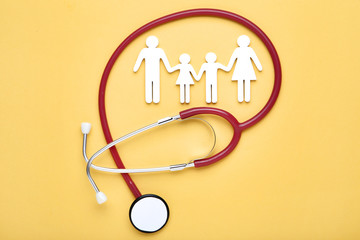 Family figures with stethoscope on yellow background