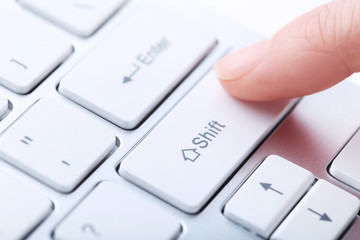 Female hand typing on computer keyboard