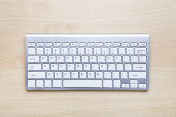 Computer keyboard on brown wooden table