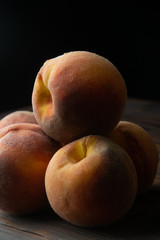 slide of fragrant peaches on a wooden table