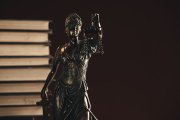 Naklejka premium Attorney and notary concept. Books and Statue of Justice isolated