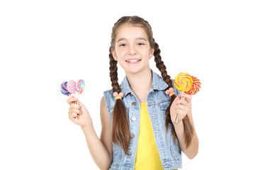 Beautiful young girl with sweet lollipops on white background