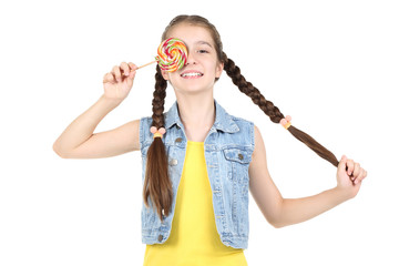 Beautiful young girl with sweet lollipop on white background
