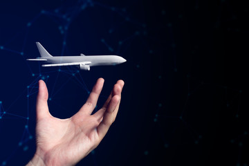 businessman hand and the floating airplane model toy with web background in travel airline business and technology internet online network concept