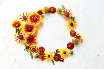 Flower composition on a wooden white background