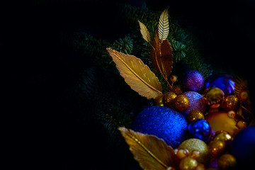 Blue and golden Christmas balls on a christmas tree closeup view in a low key with a copy space - 287441808