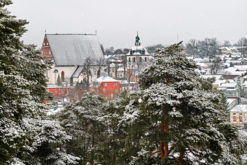 Old historic Porvoo, Finland with wooden houses and medieval stone and brick Porvoo Cathedral under white snow in winter - 287442004