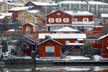 Old historic Porvoo, Finland with Traditional Scandinavian rural red wooden houses under white snow. Snowing - 287442058
