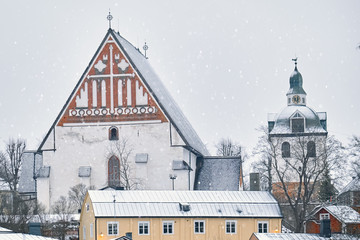 Old historic Porvoo, Finland with wooden houses and medieval stone and brick Porvoo Cathedral under white snow in winter - 287442063