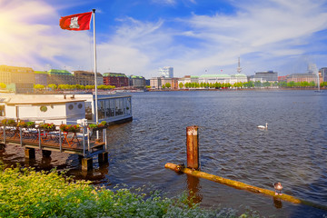 Beautiful view with Hamburg flag on sunny summer day at the Alster lake in Hamburg, Germany - 287442203