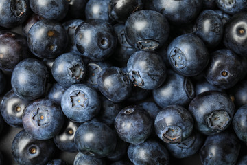 Fresh tasty blueberries as background, top view