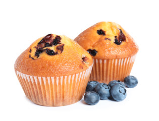 Tasty muffins with blueberries on white background