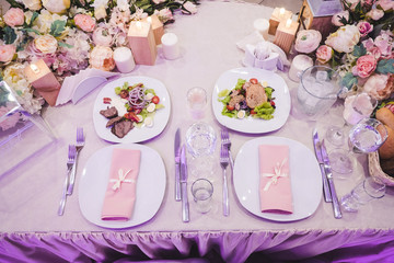 Colorful bright decorated with flowers and candles wedding table. Top view shot.