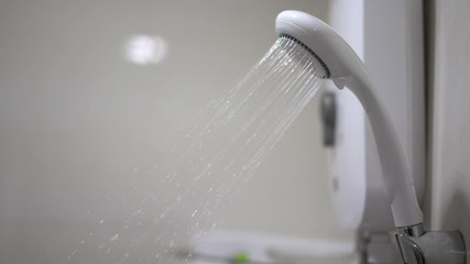shower head with water spraying. Bath room shower with flowing water.