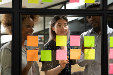 Multiethnic business team brainstorm write ideas on sticky notes
