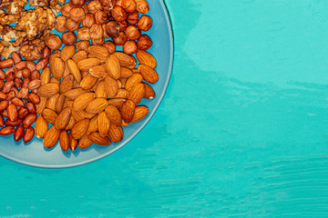Assorted nuts in a blue plate.