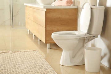 Fototapeta na wymiar White toilet bowl in modern bathroom interior