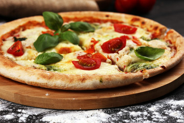 vegetarian italian Pizza with tomatoes, mozzarella cheese  and basil. Delicious italian pizza