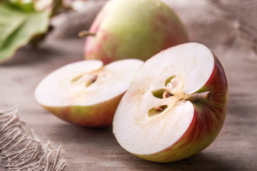 cut apples close up on old wooden background