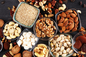 Composition with dried fruits and assorted healthy nuts on rustic background