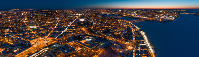 Aerial panoramic view of Nizhny Novgorod, Russia, illuminated at night. The Spit (confluence of Oka and Volga Rivers) and the Nizhny Novgorod Kremlin.