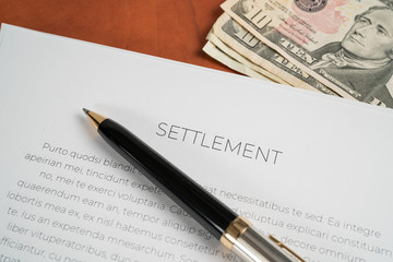 Settlement papers wit a pen