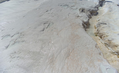 Snow-white salt deposits on the stone slopes created natural patterns.