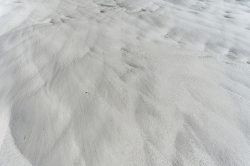 Snow-white salt deposits on the stone slopes created natural patterns.