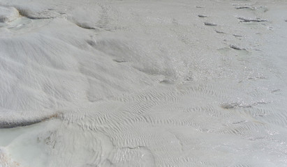 Snow-white salt deposits on the stone slopes created natural patterns.