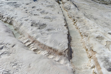 Snow-white salt deposits on the stone slopes created natural patterns.
