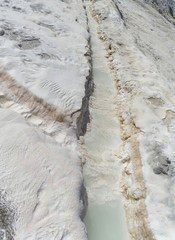 Snow-white salt deposits on the stone slopes created natural patterns.