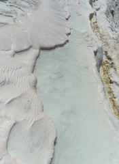 Snow-white salt deposits on the stone slopes created natural patterns.